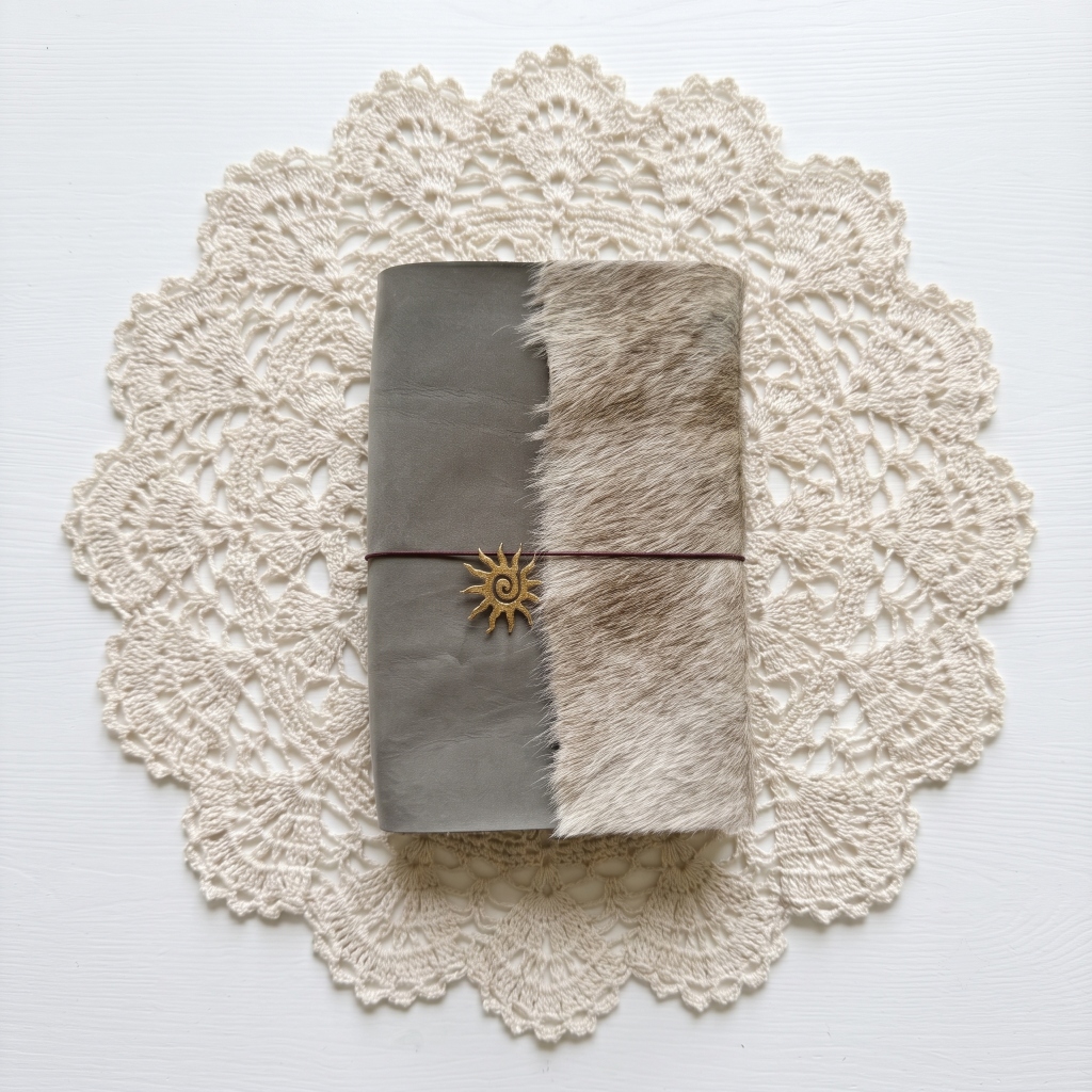 grey suede cowhide trifold with sun charm