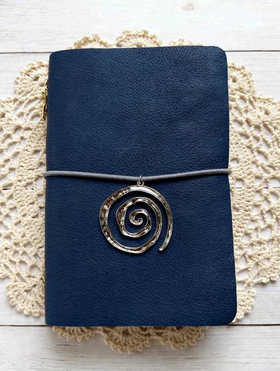 navy leather journal with grey elastic cord and silver spiral charm