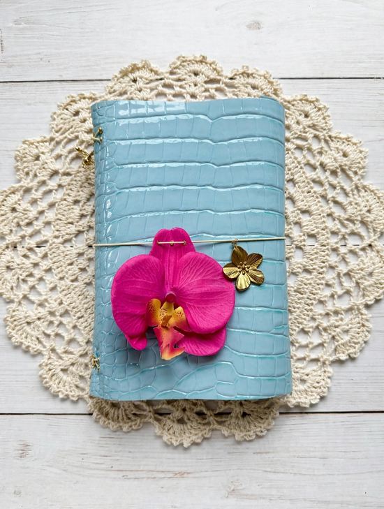 light blue croc-embossed journal with pink orchid and gold flower charms